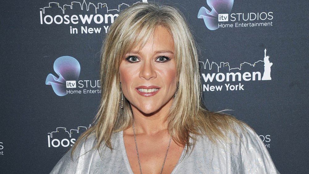 Samantha Fox posing in a silver dress at a DVD launch in 2010