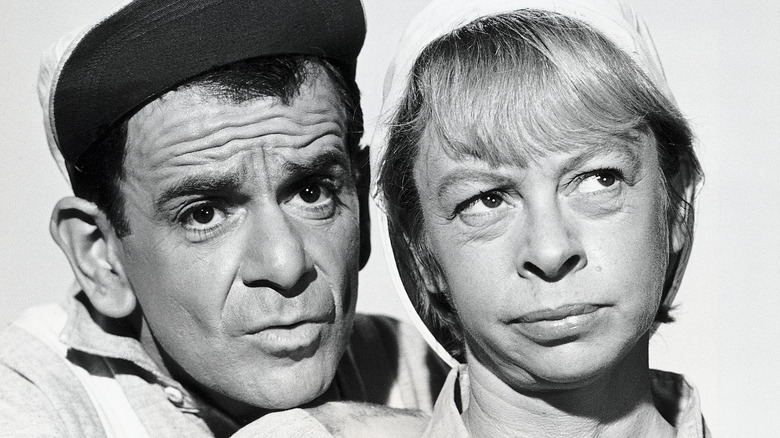 Sid Melton and Mary Grace Canfield posing for a black and white photo on set