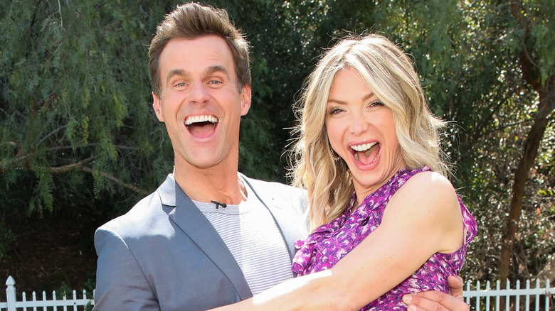 Cameron Mathison carrying Debbie Matenopoulos