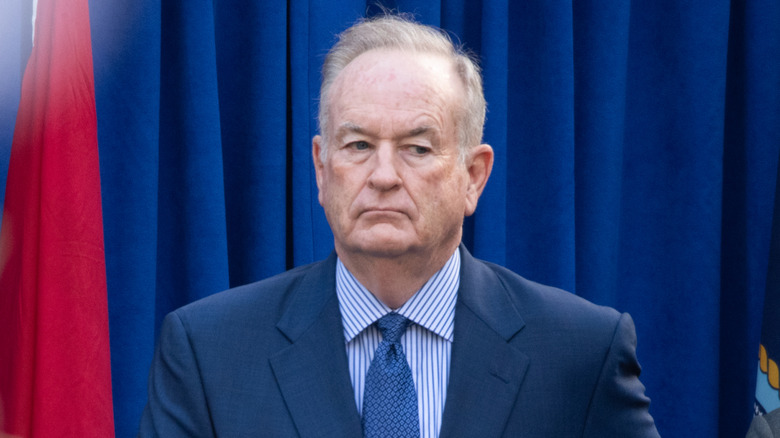 Bill O'Reilly in front of a blue curtain