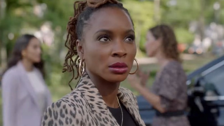 Shanola Hampton in a a patterned blazer and hoop earrings.