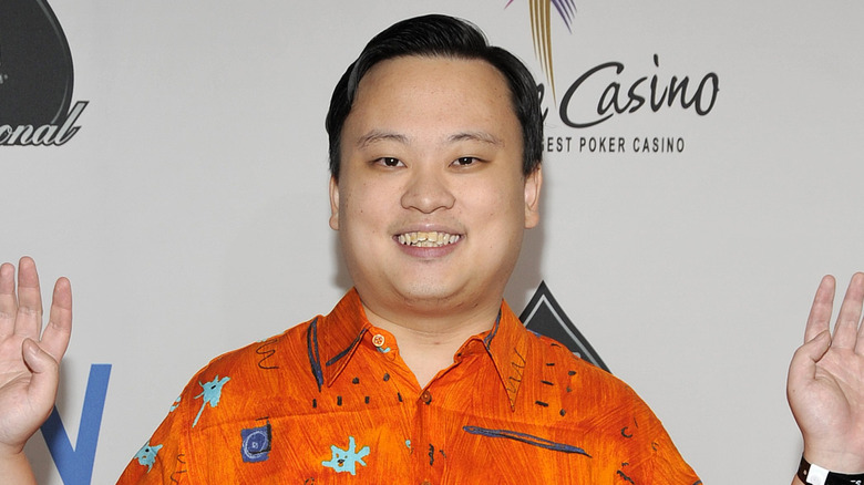 William Hung smiling and posing with his hands up