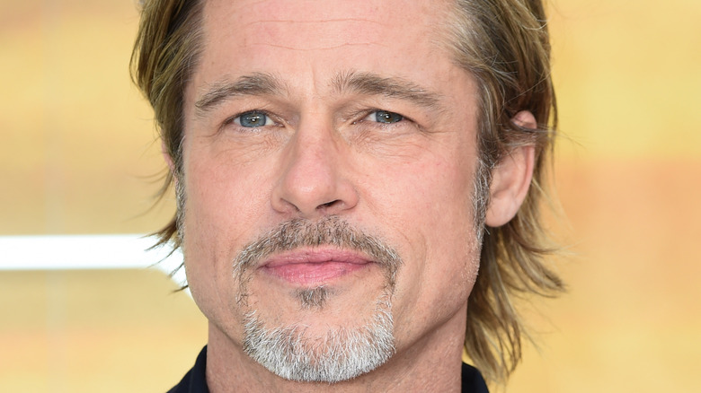 Brad Pitt posing for cameras on red carpet