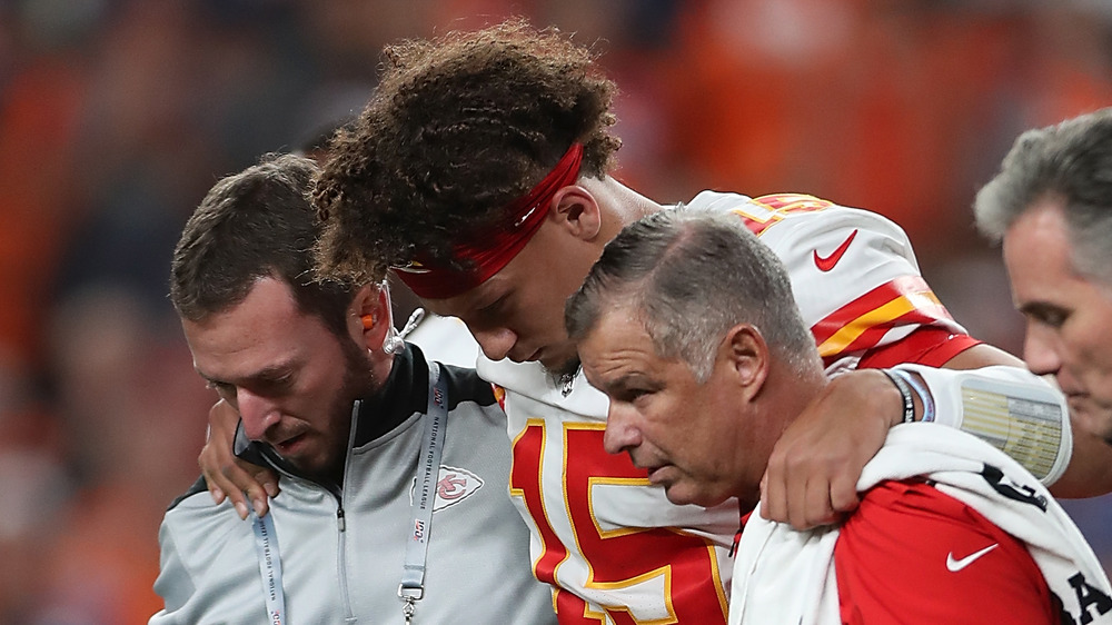 Patrick Mahomes being helped off the field after an injury