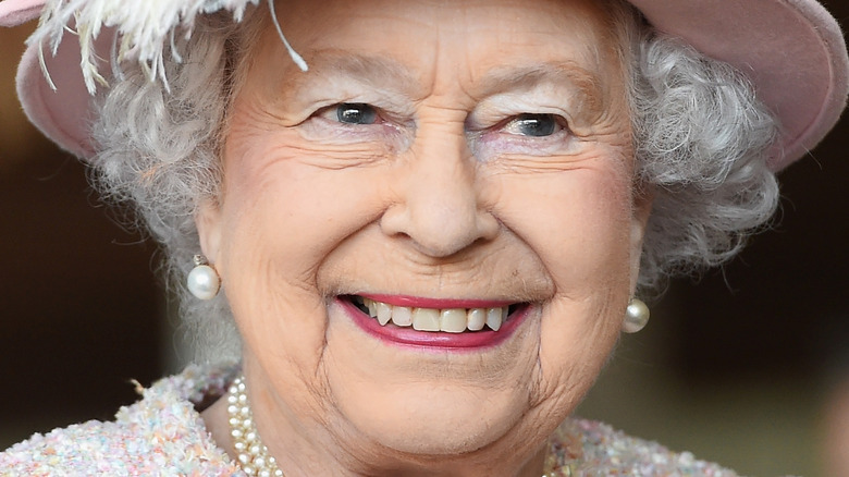 Queen Elizabeth II smiles at the Chichester Theatre