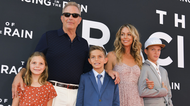 Kevin Costner and Christine Baumgartner posing with their children