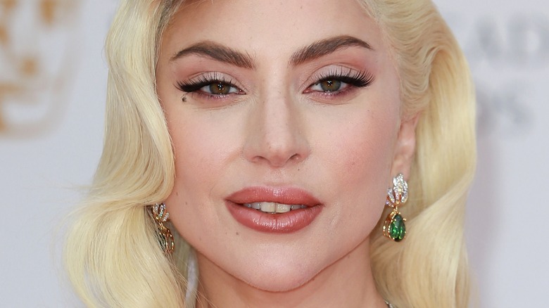 Lady Gaga wears green dangle earrings