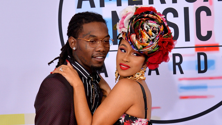 Cardi B holding Offset's shoulders