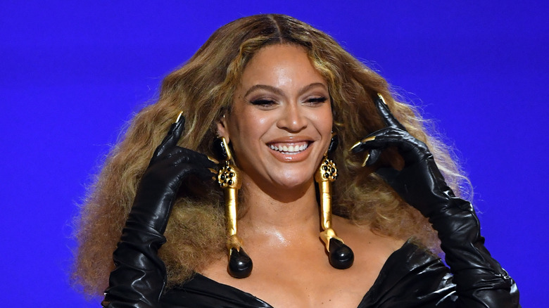 Beyonce holding her hair back and smiling