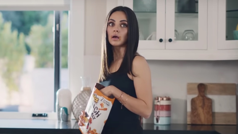 Mila Kunis eating Cheetos in Super Bowl ad