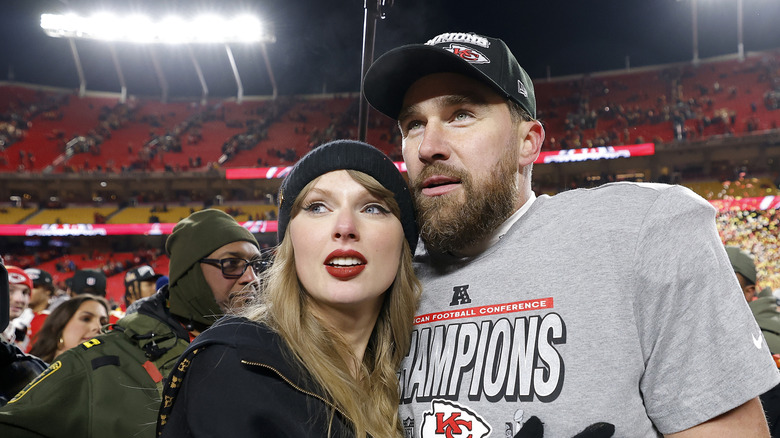 Taylor Swift grabbing Travis Kelce at the AFC championship game