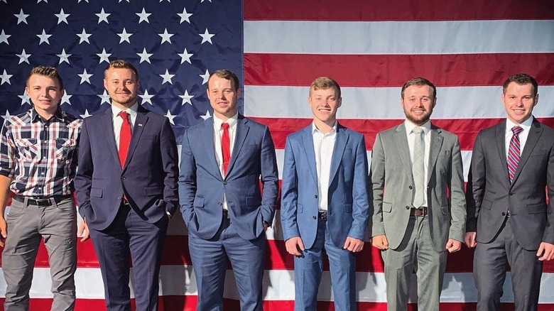 Duggar brothers in front of American flag