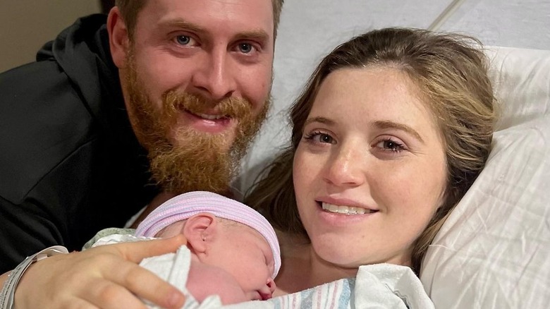 Joy-Anna Duggar and Austin Forsyth smiling with their baby