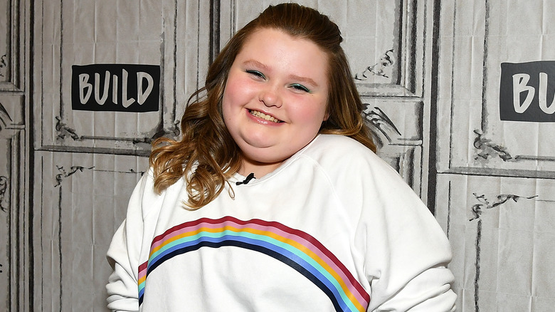 Alana Thompson smiling in rainbow sweater