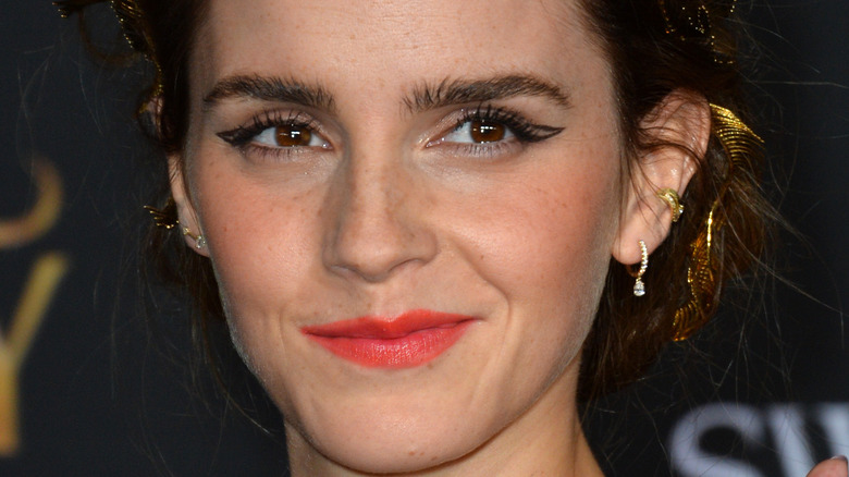 Emma Watson poses in red lipstick