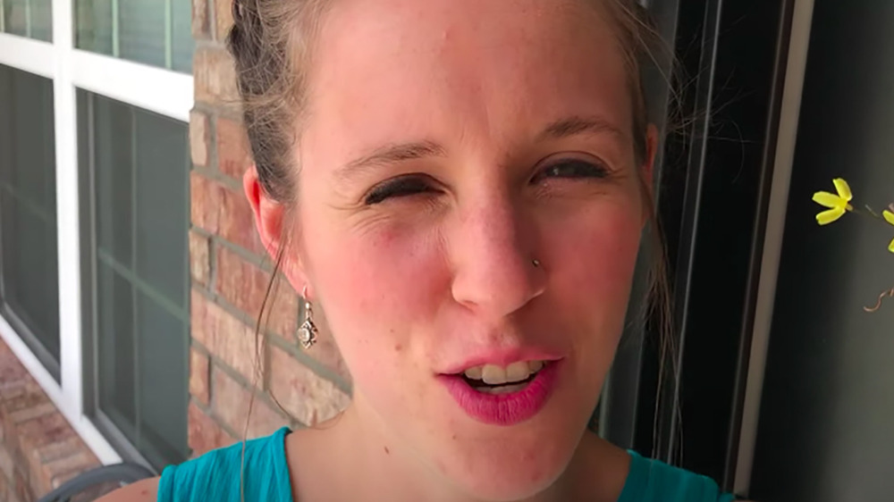 Jill Duggar in front of her new house.