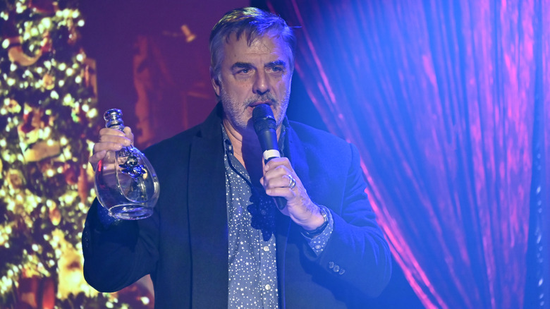 Chris Noth holding a bottle