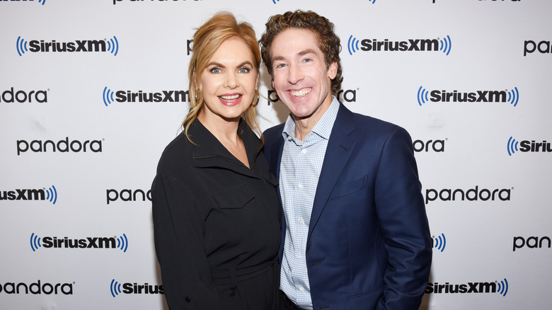 Victoria Osteen and Joel Osteen smiling at an event