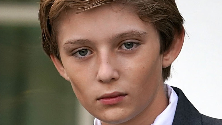 Barron Trump with a neutral expression