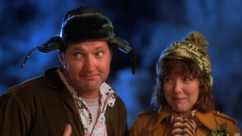 Randy Quaid and Miriam Flynn wearing warm hats outdoors in Christmas Vacation.