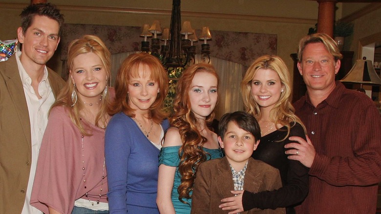 The cast of Reba smiling on the show's set