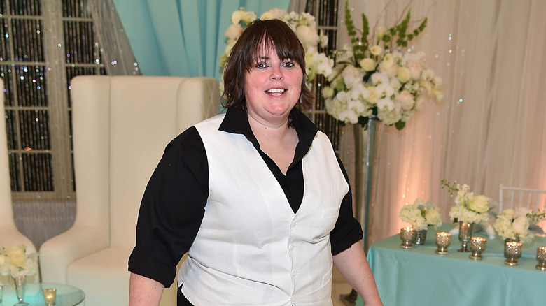 Tracey Bloom in white vest