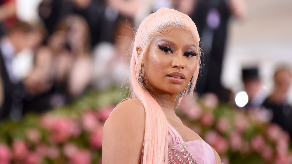 Nicki Minaj with a blonde high ponytail and pink dress