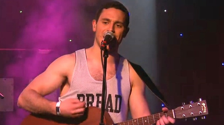 John Moustis singing and playing guitar