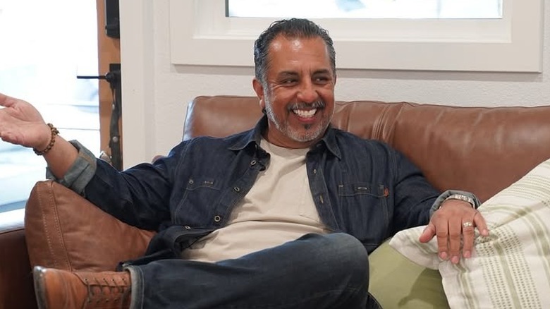 Izzy Battres posing for cameras on sofa