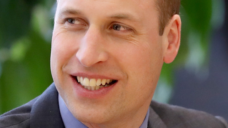 Prince William smiling and looking to the side