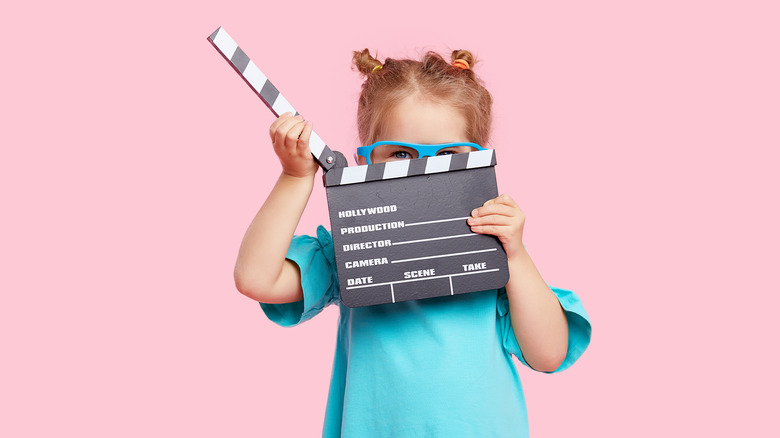 Child holding clapperboard