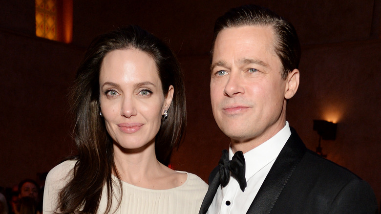 Angelina Jolie and Brad Pitt posing and smiling
