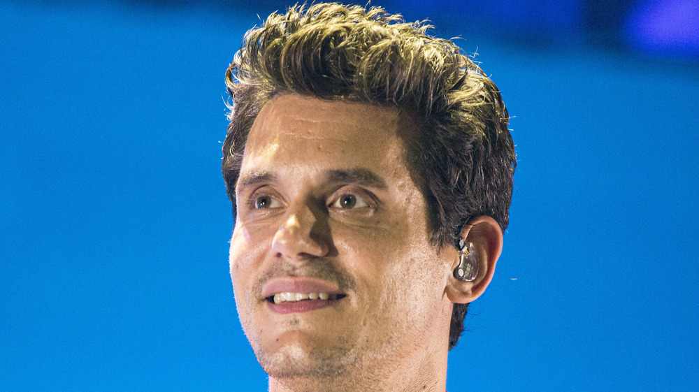 John Mayer looking up smiling