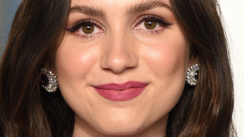 Maude Apatow smiles at an event 