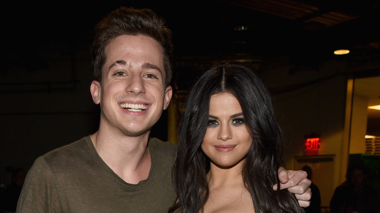 Charlie Puth with arm around Selena Gomez