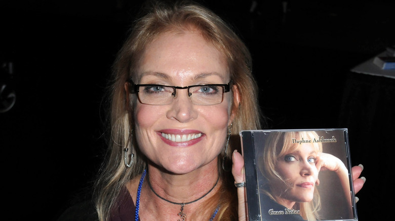Daphne Ashbrook posing with a CD.