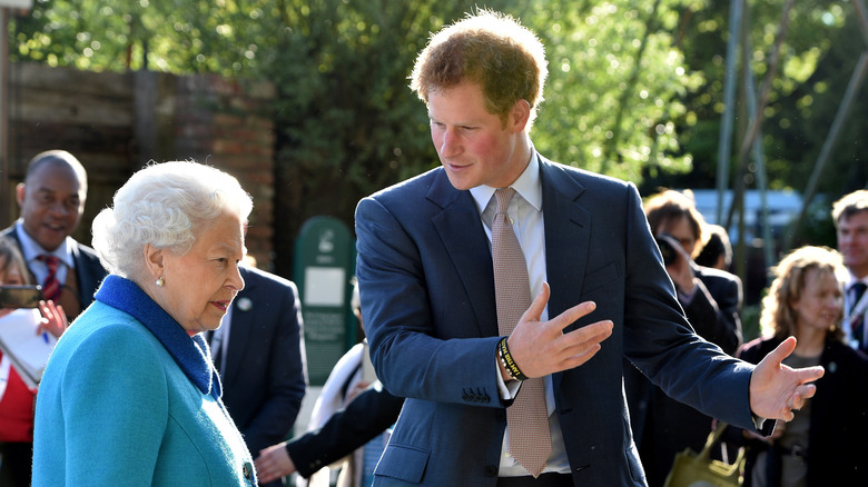 Prince Harry gesturing to Queen Elizabeth II