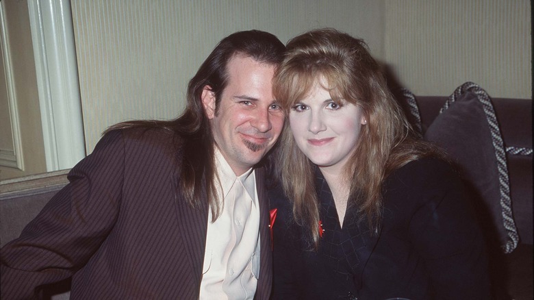 Trisha Yearwood and Robert Reynolds smile and pose at a 1995 Grammy party
