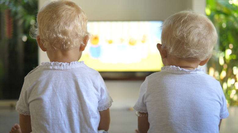 two toddlers watching TV