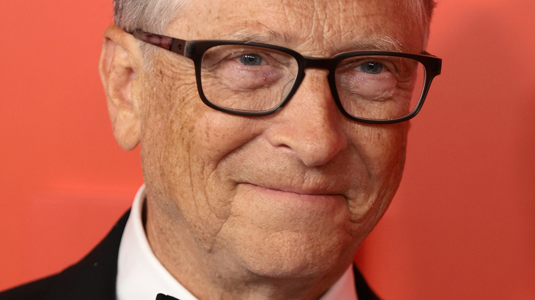 Bill Gates smiles in black-frame glasses