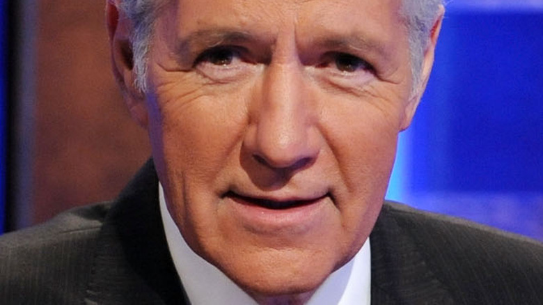 Alex Trebek smiling on Jeopardy! set