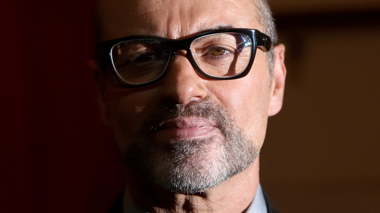 George Michael donning black glasses