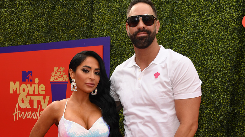 Angelina Pivarnick poses alongside Chris Larangeira on the red carpet