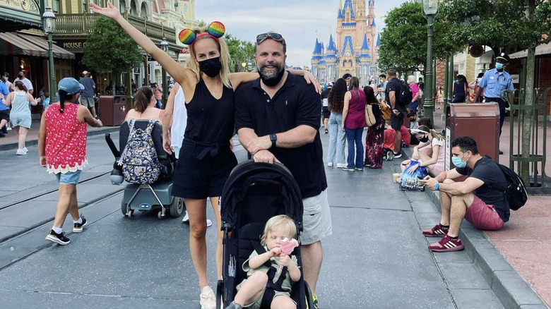 Angie Harrington, Chris Harrington and child posing for photo at Disney World
