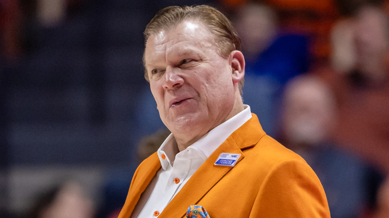 Brad Underwood wearing an orange suit during a game at State Farm Center