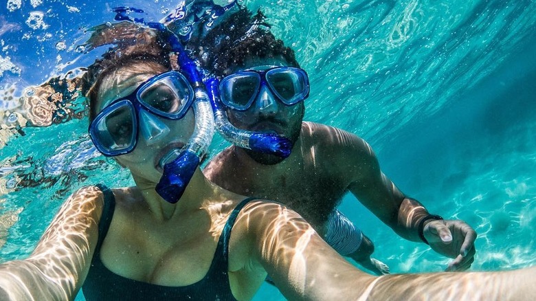 Amanda Carter and Bubba Wallace posing underwater 