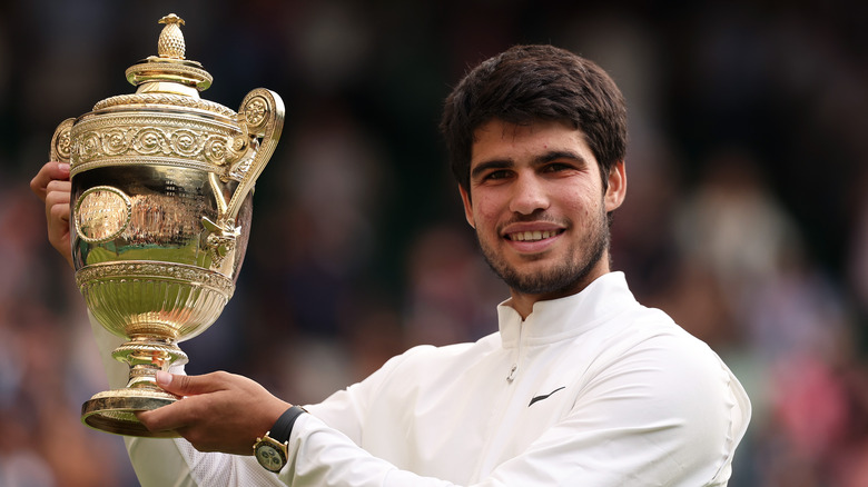 Carlos Alcaraz holding Wimbledon trophy