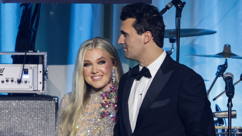 Charlie Kirk and his wife, Erika Frantzve, on stage.