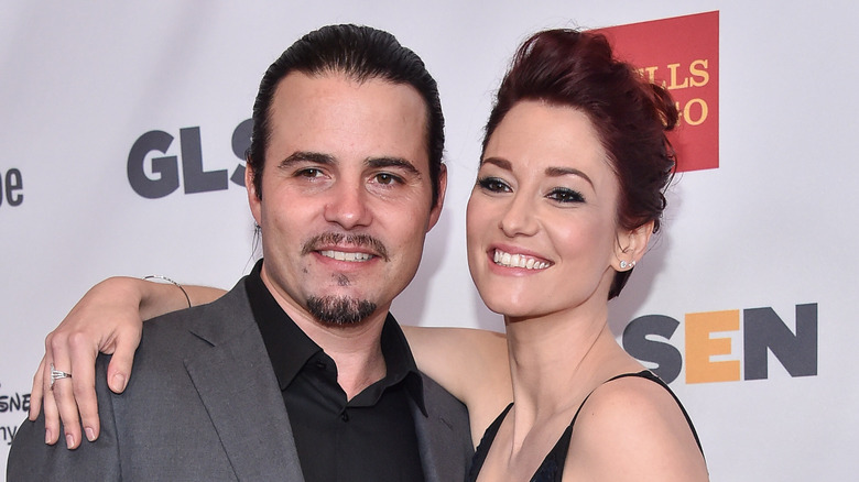 Nathan West smiles alongside wife Chyler Leigh on the red carpet