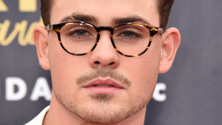 Dacre Montgomery posing for picture with glasses on